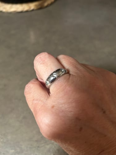Close-up of a customer's hand wearing the silver-colored Trio Gem Dome Ring.