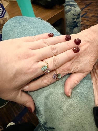 Customer showing two hands, each wearing a beautiful Navae Birthstone Ring.