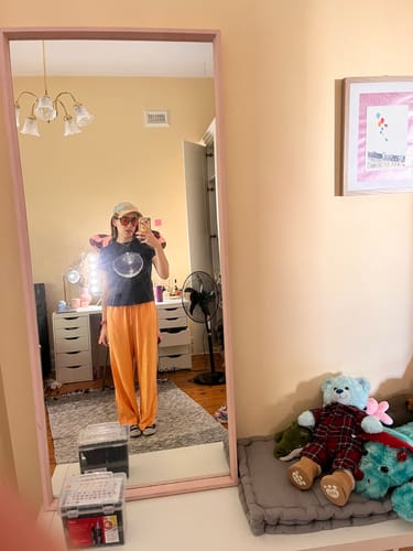 Reviewer's full-body mirror selfie showing the fit of the navy Studio 54 baby tee.