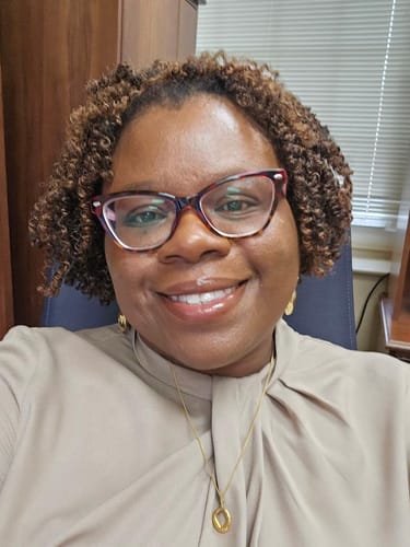 Customer wearing the Zola Geometric Gold Necklace, which complements their gold earrings.