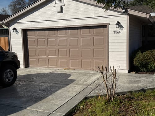 Customer's home with a taupe-colored garage door used as an accent color.