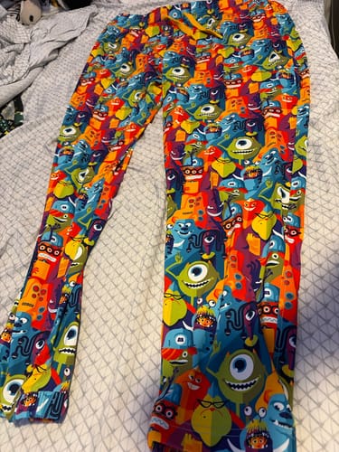 Customer's colorful Monsters, Inc. joggers with a character print, laid out flat.