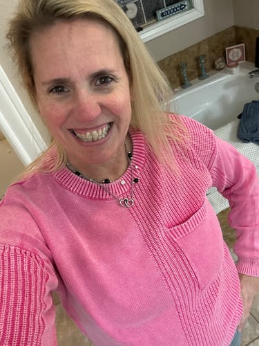 Customer wearing the pink Mineral Washed Relaxed Fit Sweater, showing its comfortable fit and chest pocket.