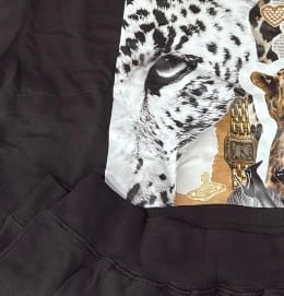 Close-up of a reviewer's black college hoodie, showing the ribbed hem and a large custom animal graphic.