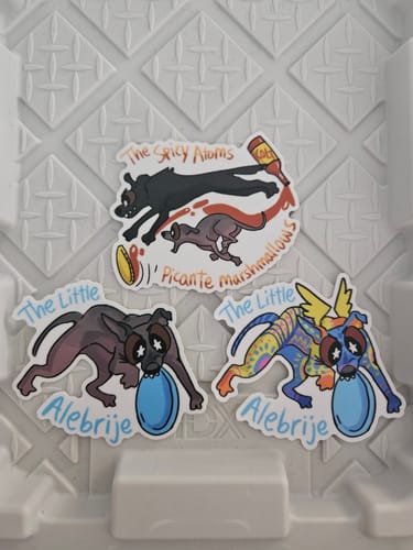 Reviewer's three colorful custom vinyl stickers featuring cartoon dog designs.