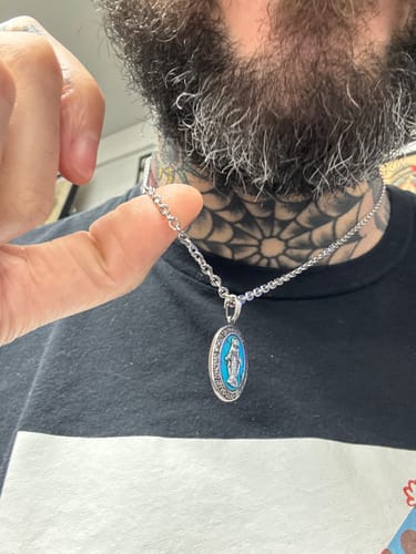 Close-up of a reviewer wearing the shiny, silver 3mm Flat Anchor Oval Link Chain with a pendant.