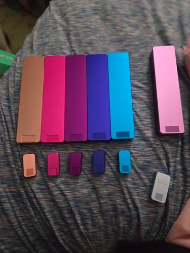 Reviewer's colorful collection of Weekly Case pill organizers in both weekly and nano sizes.