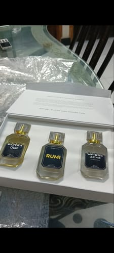 Customer's open Winter Box with the three perfume bottles—Black Oud, Rumi, and Ombre Leather—sitting inside on a table.