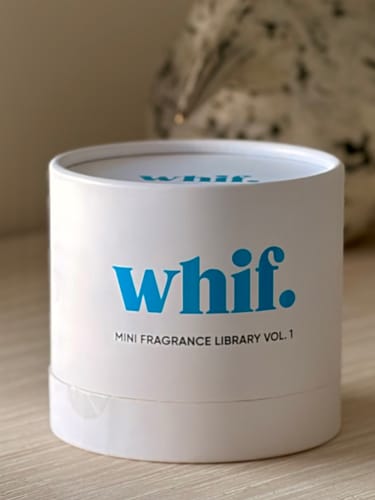 Customer's Whif Mini Fragrance Library Vol. 1 shown in its white, cylindrical box on a surface.