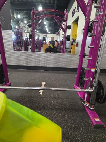 Reviewer at the gym with a shaker bottle of MTS Nutrition goBHB, preparing for a workout.