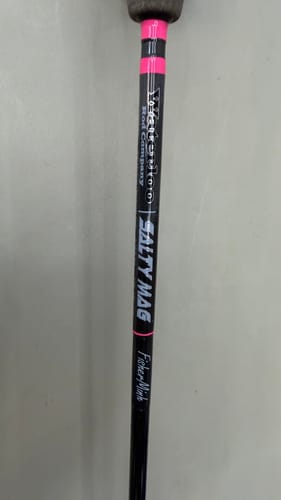 Close-up of a reviewer's black Salty Mag Recoils rod, showing the logo and pink accents.