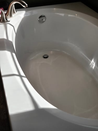 Reviewer's photo of a shiny, clean bathtub after using the Multi-Surface Concentrate.