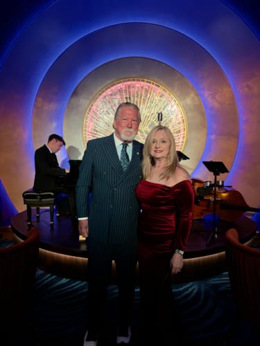 Reviewer looking elegant in the red velvet off-shoulder dress while on a cruise.