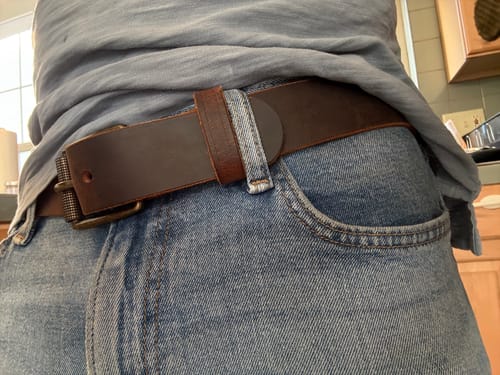 Reviewer wearing the brown Crazy Horse leather belt, showing the belt loop near a jean loop.
