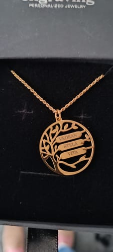 Customer's personalized Family Tree Name Necklace in a black jewelry box, showing the gold-colored pendant with three names engraved.