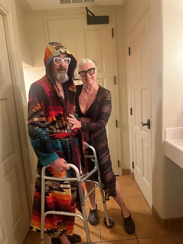 Customer using a walker stands with a companion, sharing their story about using Just Blue™ for recovery.