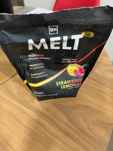 Customer's black pouch of the stim-free Melt supplement in Strawberry Lemonade flavor on a table.