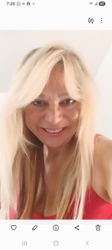 Reviewer smiling, showing clear, glowing skin after using The Micro Infusion System.