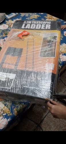 Customer showing the sealed box for their new Lot Imported Telescopic Ladder upon arrival.