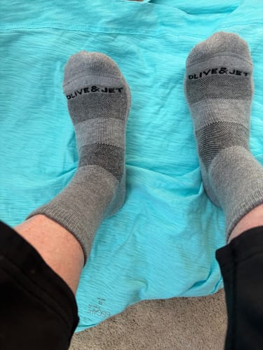 Customer's view of their feet in the comfortable, grey Quarter Socks.