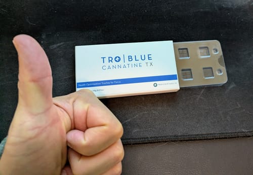 Customer giving a thumbs-up next to an open box of Blue Cannatine with the empty blister pack visible.