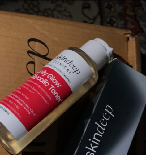 Customer's bottle of skindeep Daily Glow Glycolic Toner shown next to its product box.