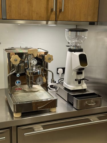 Customer's stainless steel Lelit Bianca Espresso Machine with wooden knobs, shown set up on a kitchen counter.