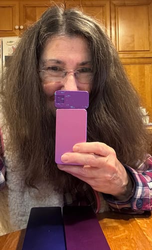 Reviewer holding up her two new lavender and purple pill cases from the 2-Pack Bundle.