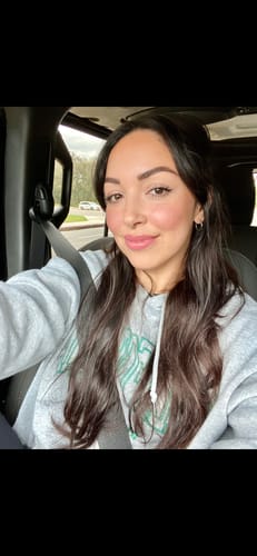 Reviewer showing their smooth, hydrated skin in a selfie after using the Glov Micro Infusion System.