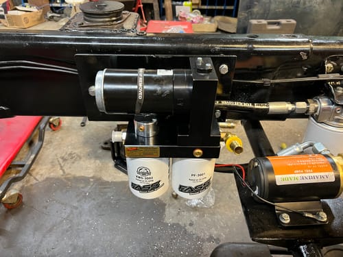 Customer's custom installation of the Cummins No Drop Series Lift Pump on a truck frame, with its two white filters clearly visible.