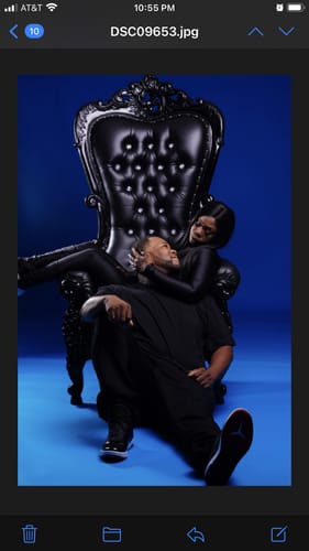 Customer's photo of a couple in a romantic pose, with one person on an ornate black throne.