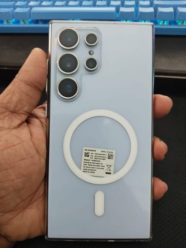 Customer holding a Galaxy S24 Ultra in the clear Magsafe case, showing the back of the phone and white magnetic ring.