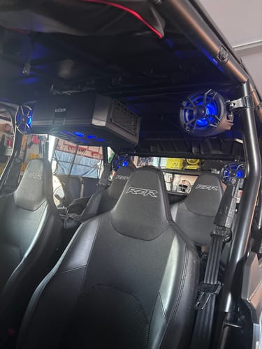 Customer's NUTV5-S QUAD PRO speaker system installed in a UTV with its blue LED lights turned on.