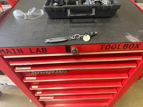 Customer's Bolt Size Finder Keychain resting on top of a red toolbox in a lab.