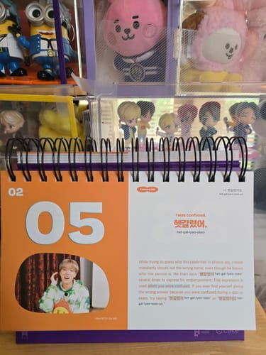 Customer's sturdy BTS - 365 BTS DAYS perpetual calendar standing open, showing an orange daily page with a photo.