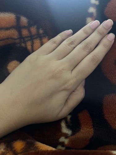 Reviewer's hand, looking smooth and even-toned after using the Body Brilliance Whitening Bundle.
