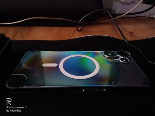 Reviewer's phone inside the Anti Yellow Magsafe Clear Case, highlighting the white magnetic ring on the back.