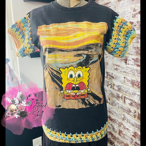Reviewer's upcycled B Grade T-Shirt with a Spongebob graphic and colorful crocheted sleeves and hem.