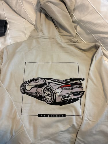 Customer's light-colored 80Eighty hoodie laid out, showing the large sports car graphic on the back.