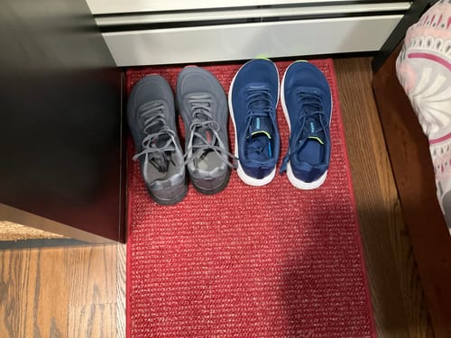 Customer shows their new blue MUUV Flow pickleball shoes next to their previous grey shoes.
