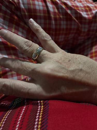 Customer showing a wide two-tone ring on their finger.