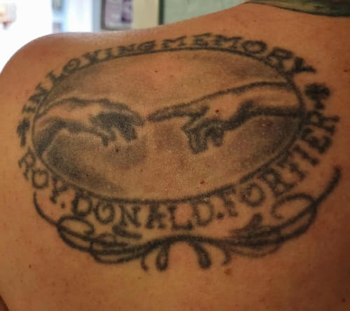 Customer's memorial tattoo showing two hands nearly touching, similar to the design of the Touch Of God Ring.