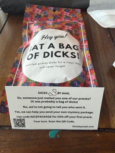 Customer's Bag of Dicks in floral packaging, displayed with the anonymous prank card from 'Dicks by Mail'.