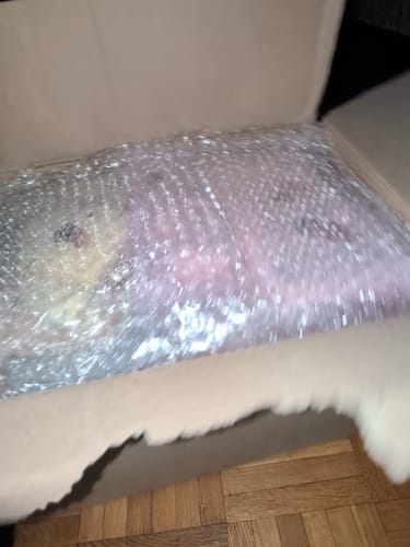 Customer's K-POP RANDOM BOX with an item wrapped securely in bubble wrap inside the open shipping carton.