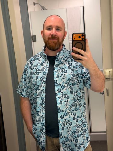 Reviewer wearing the blue Disney "Aloha Pal" shirt styled casually over a t-shirt.