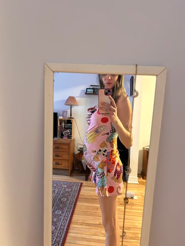 Reviewer shows a side view of the pink patterned slip nightdress, highlighting the fit during pregnancy.