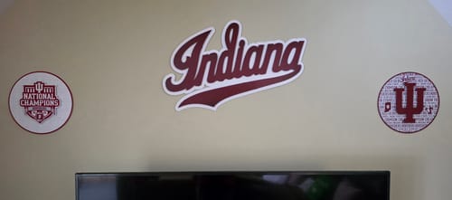 Customer's Indiana Hoosiers National Champions wall art displayed with two other IU signs on a family room wall.