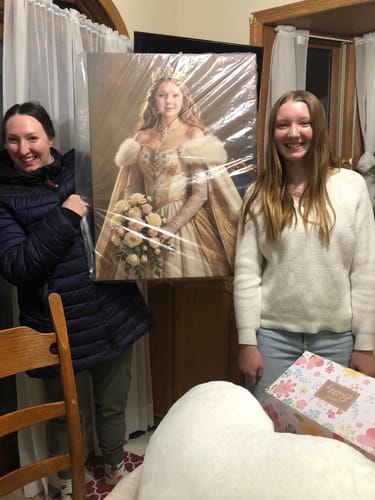 Customer and a young person holding the large, wrapped Majesty's Bouquet canvas portrait indoors.