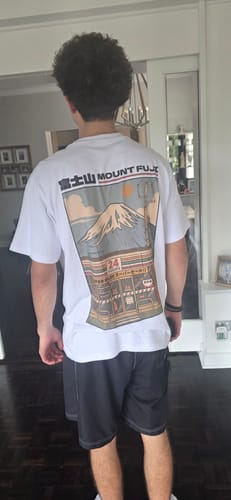 Reviewer from behind wearing the white Fuji Mart T-Shirt, showing the regular fit and Mount Fuji graphic.