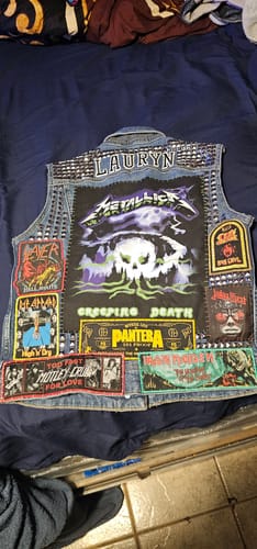 Reviewer's customized battle vest for 'Lauryn', decorated with many colorful patches.